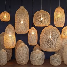 many woven lamps are hanging from the ceiling