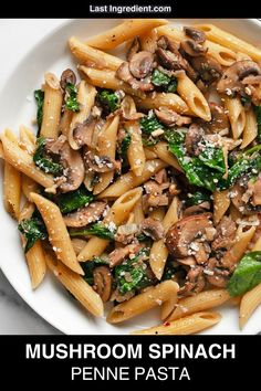 mushroom spinach penne pasta on a white plate