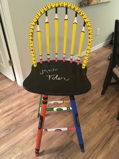 a chair made out of crayons with writing on it