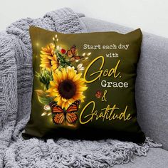 a sunflower and butterflies pillow sitting on a couch with the words, start each day with god grace and gratitude