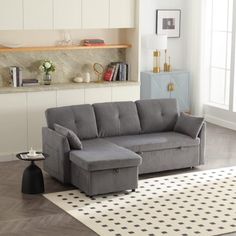 a living room with a gray couch and white rug