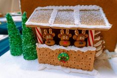 a gingerbread house decorated with reindeer and candy canes