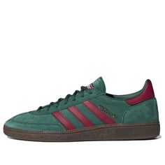 a green and red adidas sneakers on a white background