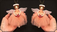 two handmade angel figurines in pink tulle with heart on black background