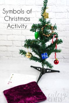 a small christmas tree sitting on top of a table next to a piece of paper