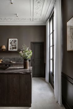 a kitchen with an island in the middle and two vases on top of it