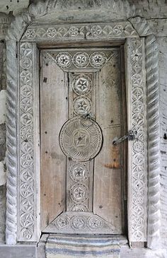 an old wooden door with intricate carvings on it