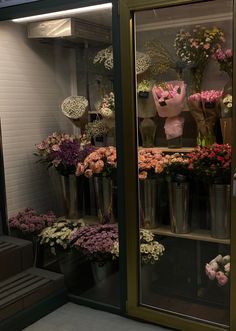 a display case filled with lots of pink and white flowers