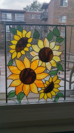 a stained glass window with sunflowers on it