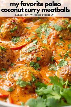 a white bowl filled with meatballs covered in sauce and garnished with cilantro