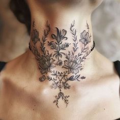 a woman's neck is adorned with flowers