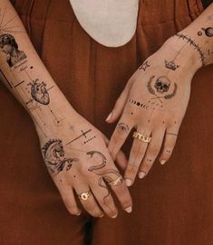 a woman's hands with tattoos on them