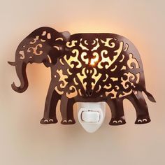 an elephant shaped night light on the wall