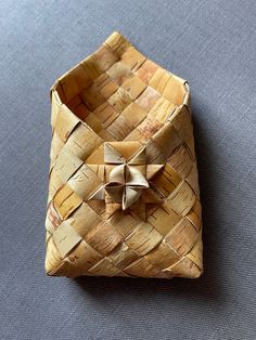 an origami box with a bow on it