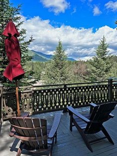 two chairs and an umbrella on a deck