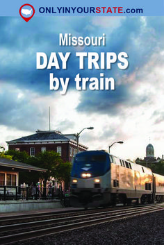 a blue and white train traveling down tracks next to a red brick building with the words missouri day trips by train