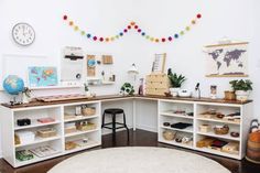 a room with several shelves and various items on the wall, including a rug in front of it