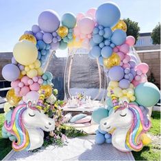 an arch decorated with balloons and unicorn heads