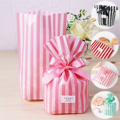 two pink and white striped bags with a flower in them sitting on a wooden table