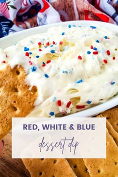 red, white and blue dessert dip on a plate with crackers in the background