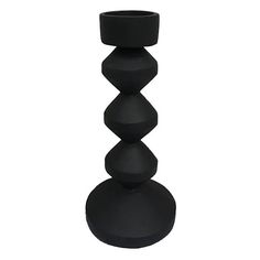 a black candle holder sitting on top of a table