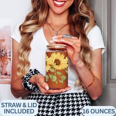 a woman holding a jar with sunflowers on it and the caption straw & lid included 16 ounces