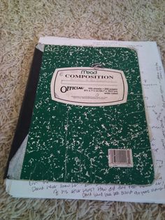 a green book with writing on it sitting on the floor