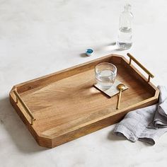 a wooden tray with two glasses on it