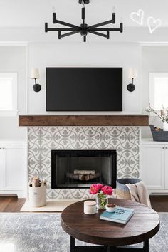 a living room with a fireplace and tv mounted above the mantel in front of it