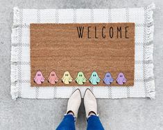 a person standing in front of a welcome mat