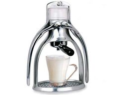 an espresso machine with a cup on the bottom and milk being poured into it