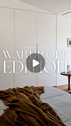 an image of a bedroom with white walls and brown blankets on the bedspread