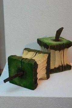 two pieces of wood that have been carved to look like apple slices