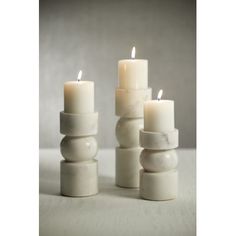 several white candles sitting next to each other