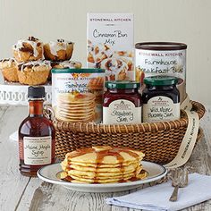 a basket filled with lots of food next to some condiments and sauces