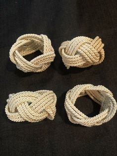 four pieces of rope laid out on a black surface