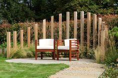 a wooden bench sitting in the middle of a garden