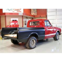 a red and black truck parked in a garage