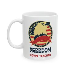 a white coffee mug with an eagle and the words, freedom lovin teacher on it