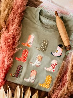 a t - shirt that has some stickers on it next to feathers and other items