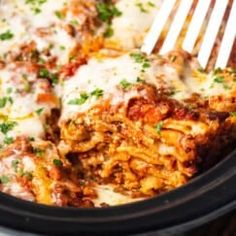 a close up of food in a crock pot with a fork sticking out of it