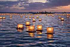 many lit candles floating in the water