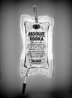 an absolut vodka bottle hanging on a wall with a cord attached to it