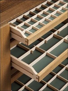 a close up of a wooden shelf with many drawers