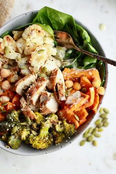 a bowl filled with broccoli, cauliflower and beans