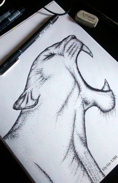 a drawing of a dog's head is shown on a piece of paper next to a pen