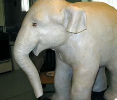 an elephant statue sitting on top of a table