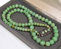 "All original jadeite jade bead necklace from 1920's. Fine polished graduated undyed natural jadeite jade beads are of a great green color. The largest beads are 10 mm (3/8\"), the smallest are 5 mm (3/16\"). The necklace is 22 1/2\" long ending with sterling silver push-in clasp adorned with 3 jade cabochons of the same color as the other beads. The clasp is also embellished with beautiful grape leaves repousse. It measures just under 1\" long, 3/8\" wide. There is no hallmarks, the clasp teste Cheap Beaded Jade Jewelry, Cheap Jade Beaded Jewelry, Luxury Jade Jewelry With Gemstone Beads, Cheap Jade Gemstone Bead Necklaces, Antique Carved Jade Pendant And Beaded Necklace, Affordable Jade Gemstone Bead Necklaces, Luxury Jade Jewelry With 108 Beads, Cheap Polished Jade Beaded Necklace, Cheap Polished Bead Jade Necklaces