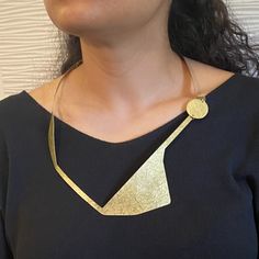 An angular study of the human figure in repose, moving, and touching. We chose brass as our only element in order to draw attention to the figure in motion. SHARE 2 - Bold Statement Necklace from the Figure Collection Gold Geometric Brass Jewelry, Modern Brass Necklaces For Gifts, Modern Brass Necklace For Gifts, Modern Brass Necklace For Gift, Modern Gold-tone Necklace For Gift, Modern Brass Pendant Necklace, Vintage Gold Jewelry With Unique Design, Handmade Geometric Gold Jewelry, Modern Gold Necklace With Large Pendant