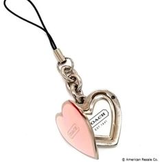 a heart shaped keychain with a tag attached to it's back end